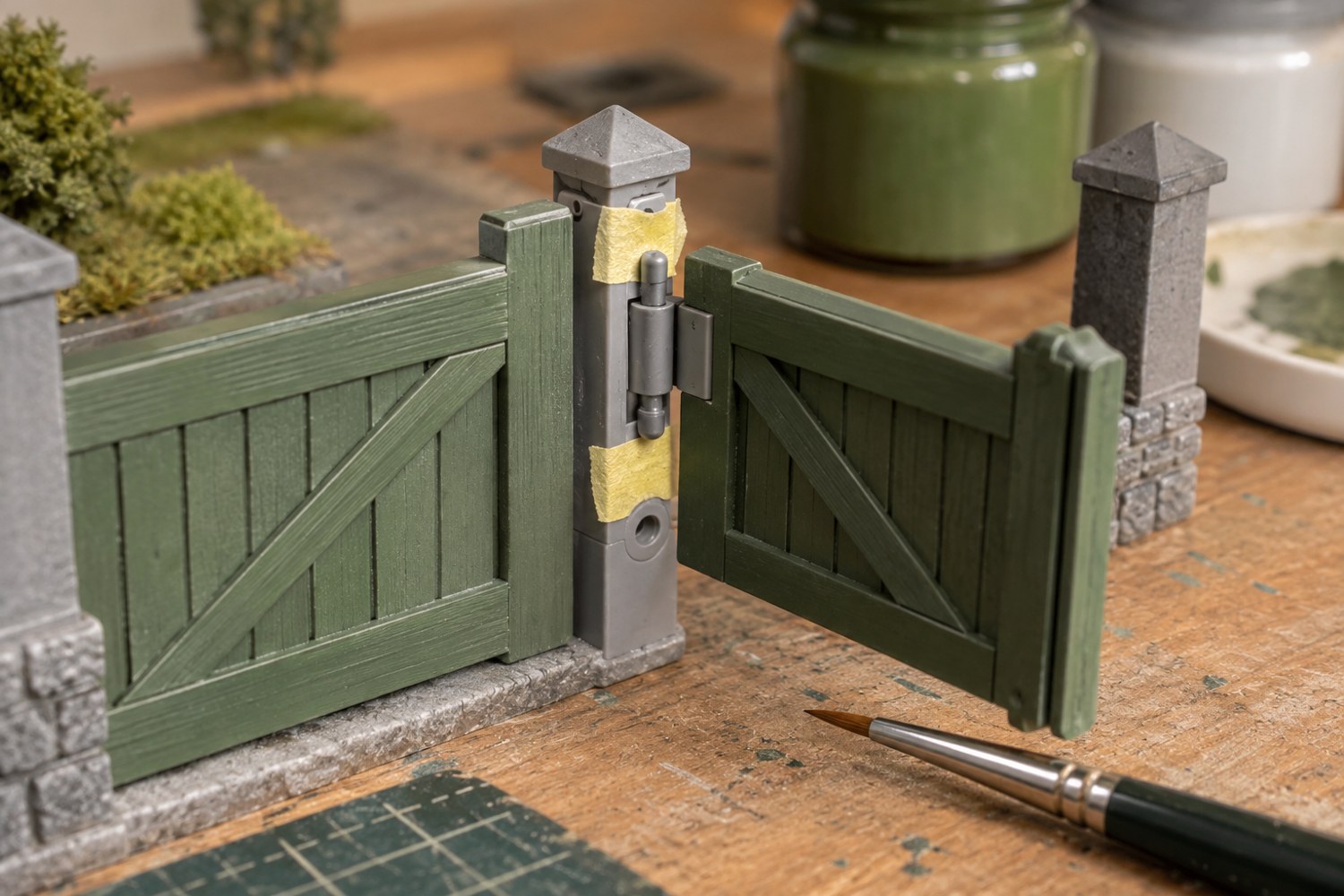 A miniature gate with its moving hinge protected from paint